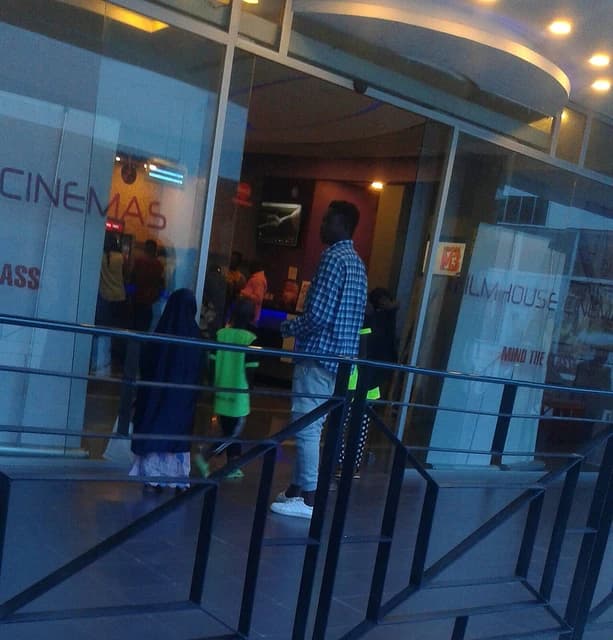 People stand outside Film House Cinema in Dugbe, Heritage Mall, Ibadan.