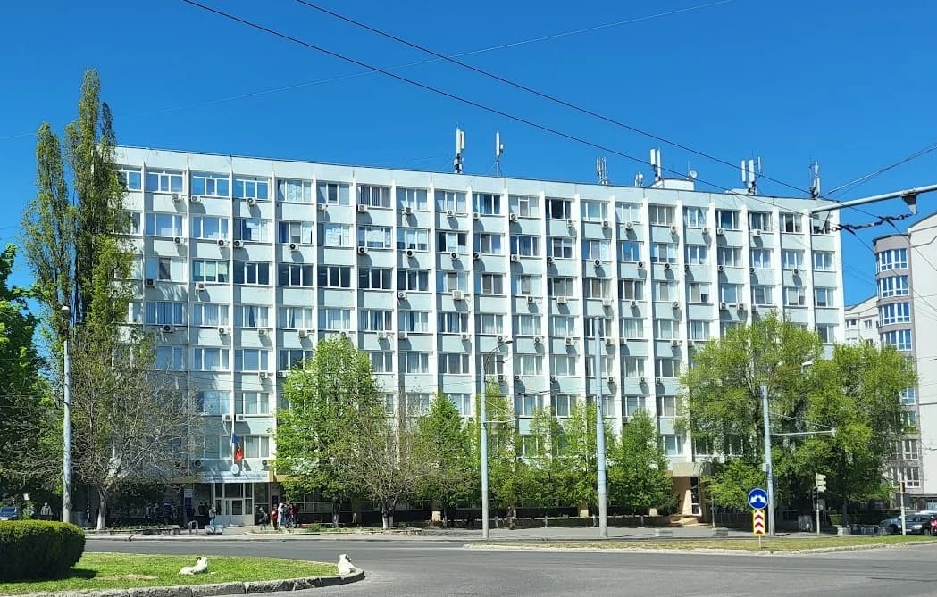Ministry of Labour and Social Protection building exterior with trees and clear blue sky.