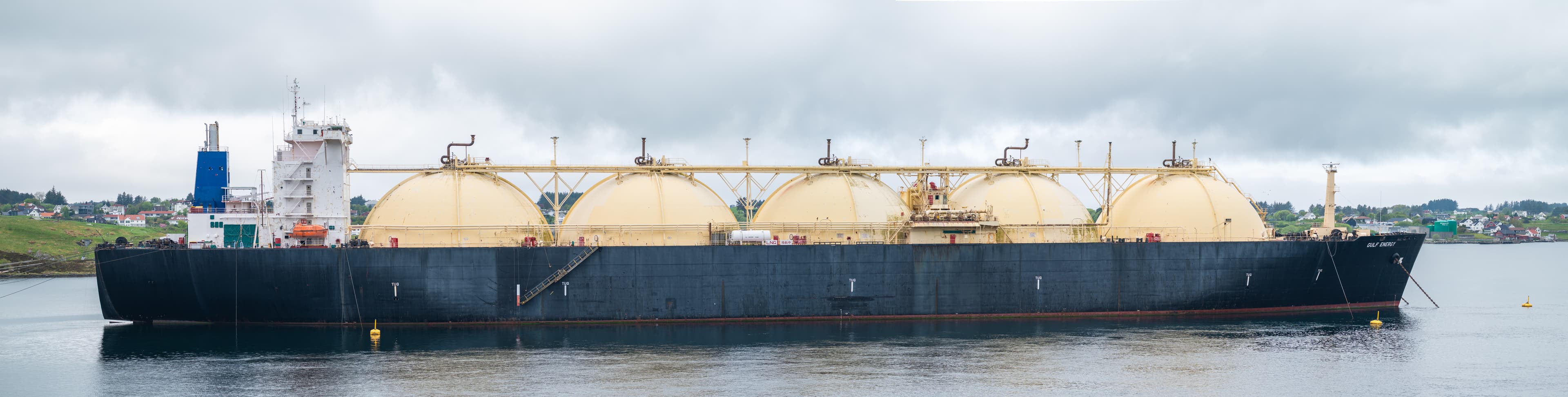 LNG tanker GULF ENERGY, IMO 7390143, sails on water under a cloudy sky.