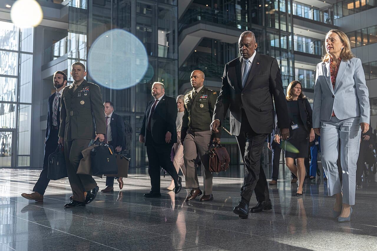 United States Secretary of Defense Lloyd J. Austin III and Ambassador Julianne Smith walk at NATO Headquarters.