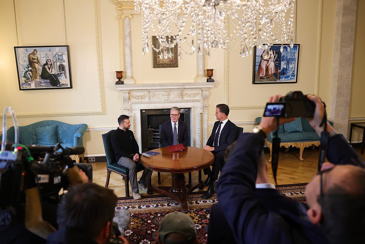 Prime Minister Keir Starmer, President Volodymyr Zelenskyy, and NATO General Secretary Mark Rutte seated at a table.